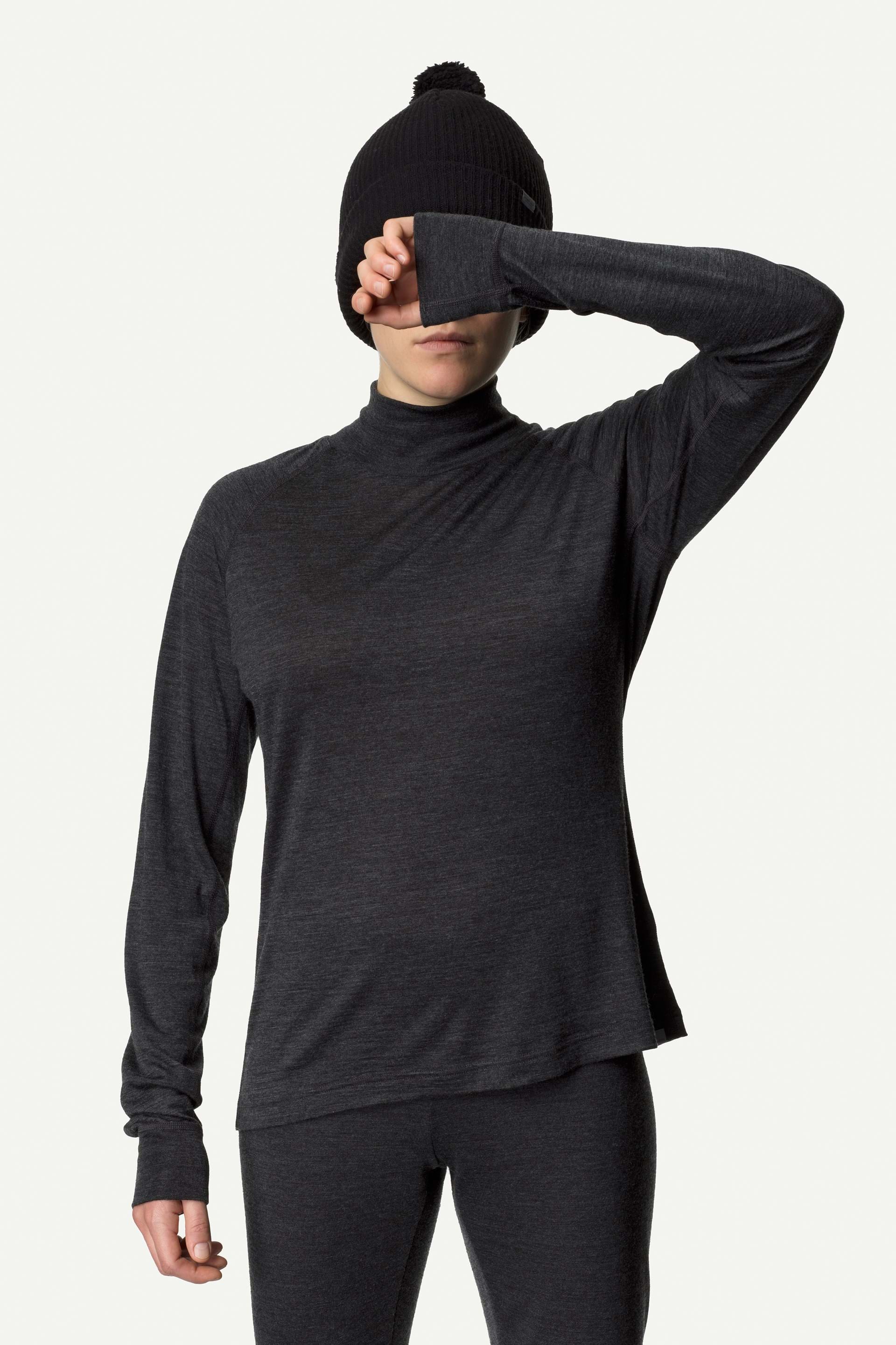 Woman wearing a black merino wool turtleneck, great for biking in cold weather.